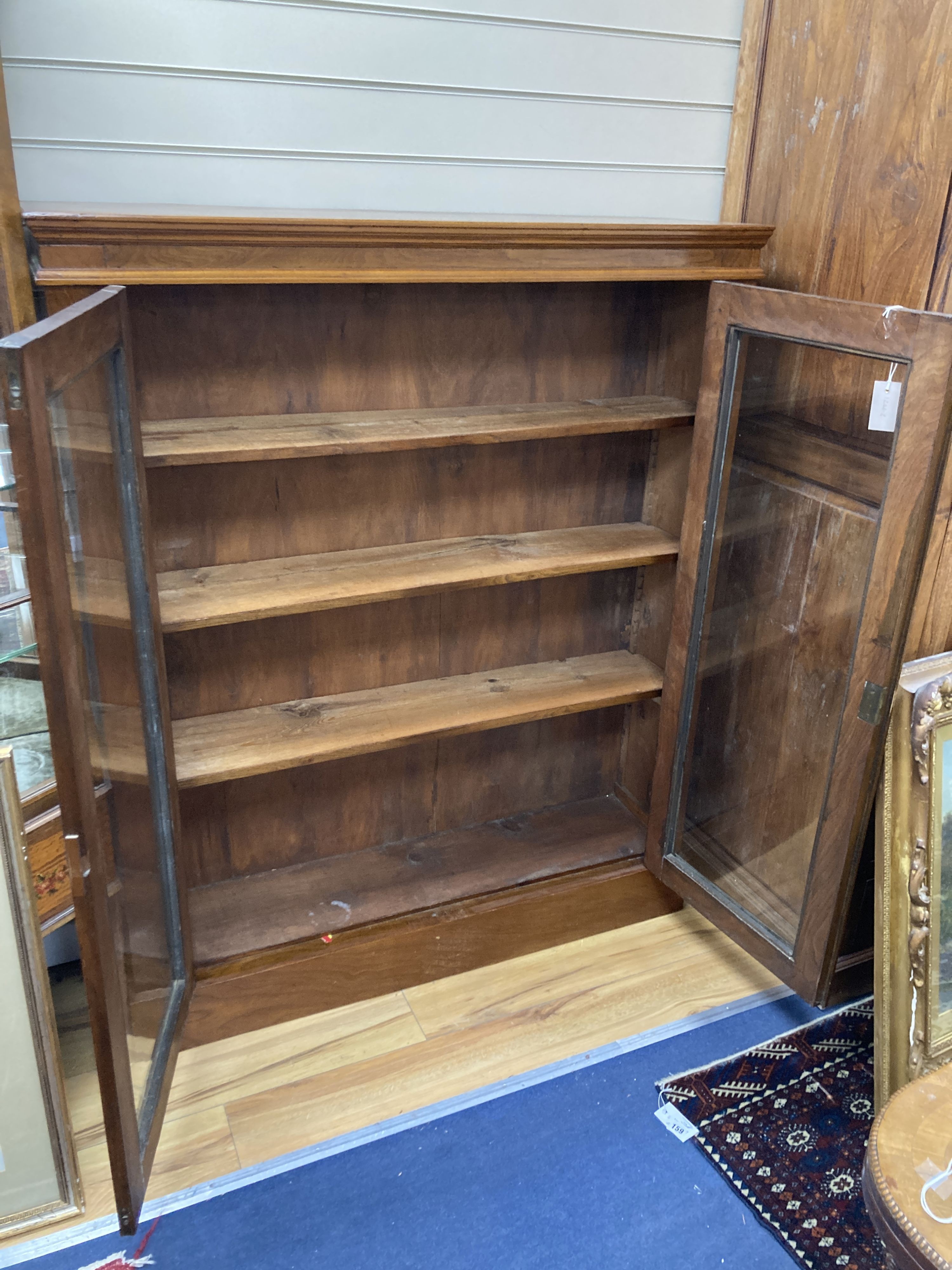 A late Victorian glazed walnut bookcase. W-112, D-28, H-138cm.